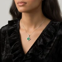 model wearing beautiful square shaped silver pendant with green onyx and cubic zirconia