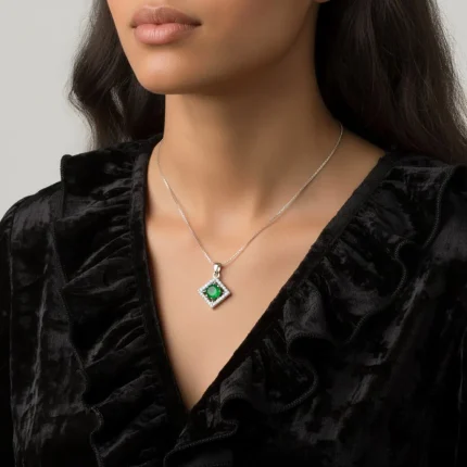 model wearing beautiful square shaped silver pendant with green onyx and cubic zirconia