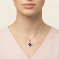 model wearing beautiful square shaped silver pendant with garnet and cubic zirconia