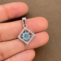 beautifully portraying blue topaz and cubic zirconia together creating square shaped silver pendant