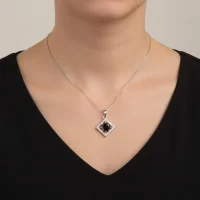 model wearing beautiful square shaped silver pendant with black onyx and cubic zirconia