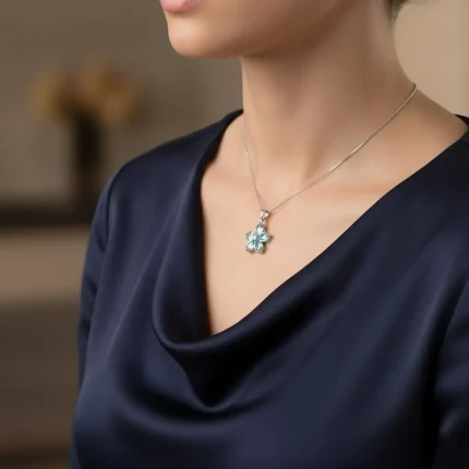model wearing blue topaz silver pendant with cubic zirconia